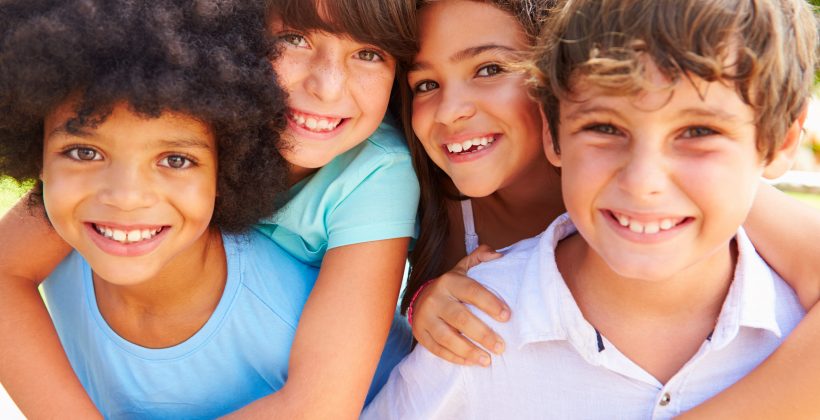 four kids all smiling