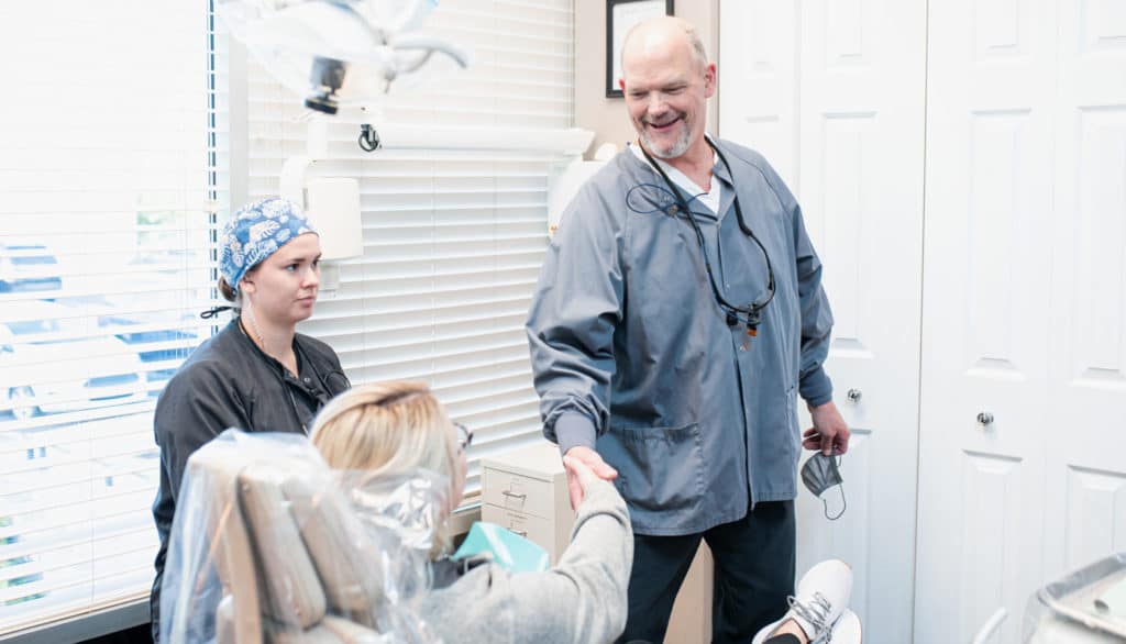 dr. mike rothan shaking hands with a patient