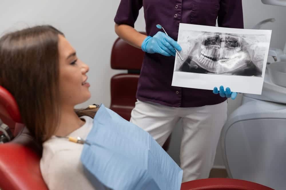 patient being showed an x-ray of her mouth