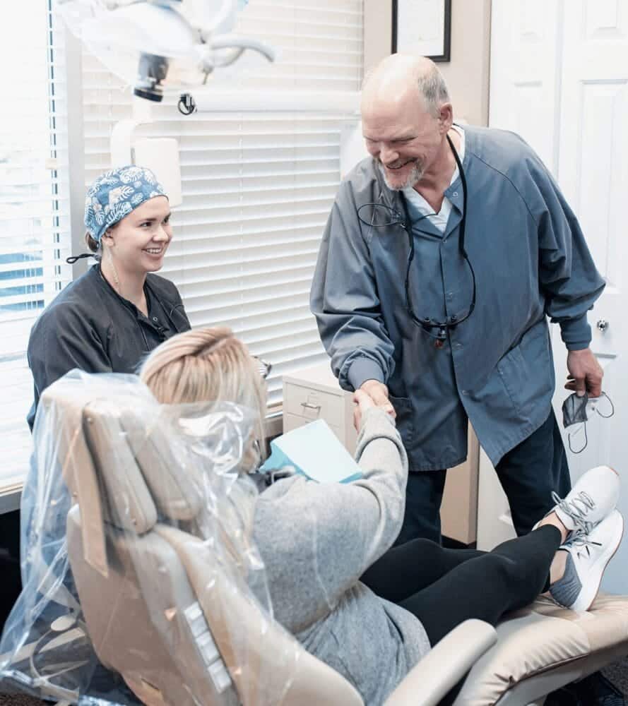 Dr Mike Rothan shaking hands with female dental patient