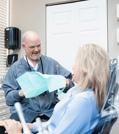 Dr Mike Rothan discussing dental emergency with patient